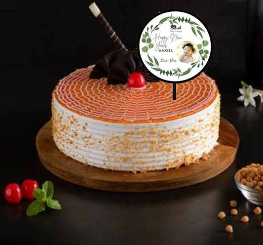 Buy or send online New Year Special Butterscotch Cake along with customised topper by Bakers Wagon