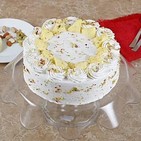 Online Vanilla Flavoured Pista Rasmalayi Cake Delivery by Baker's Wagon