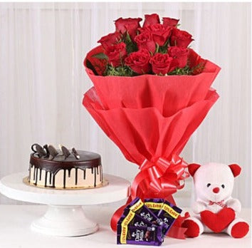 OnlineBe Mine Combo of Roses, Chocolate Cake, Chocolates and Teddy Delivery with Baker's Wagon
