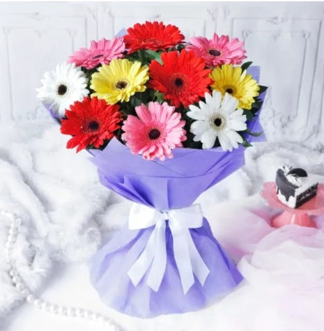 Buy/Send Mixed Gerbera in Blue Wrap with online delivery from Baker's Wagon